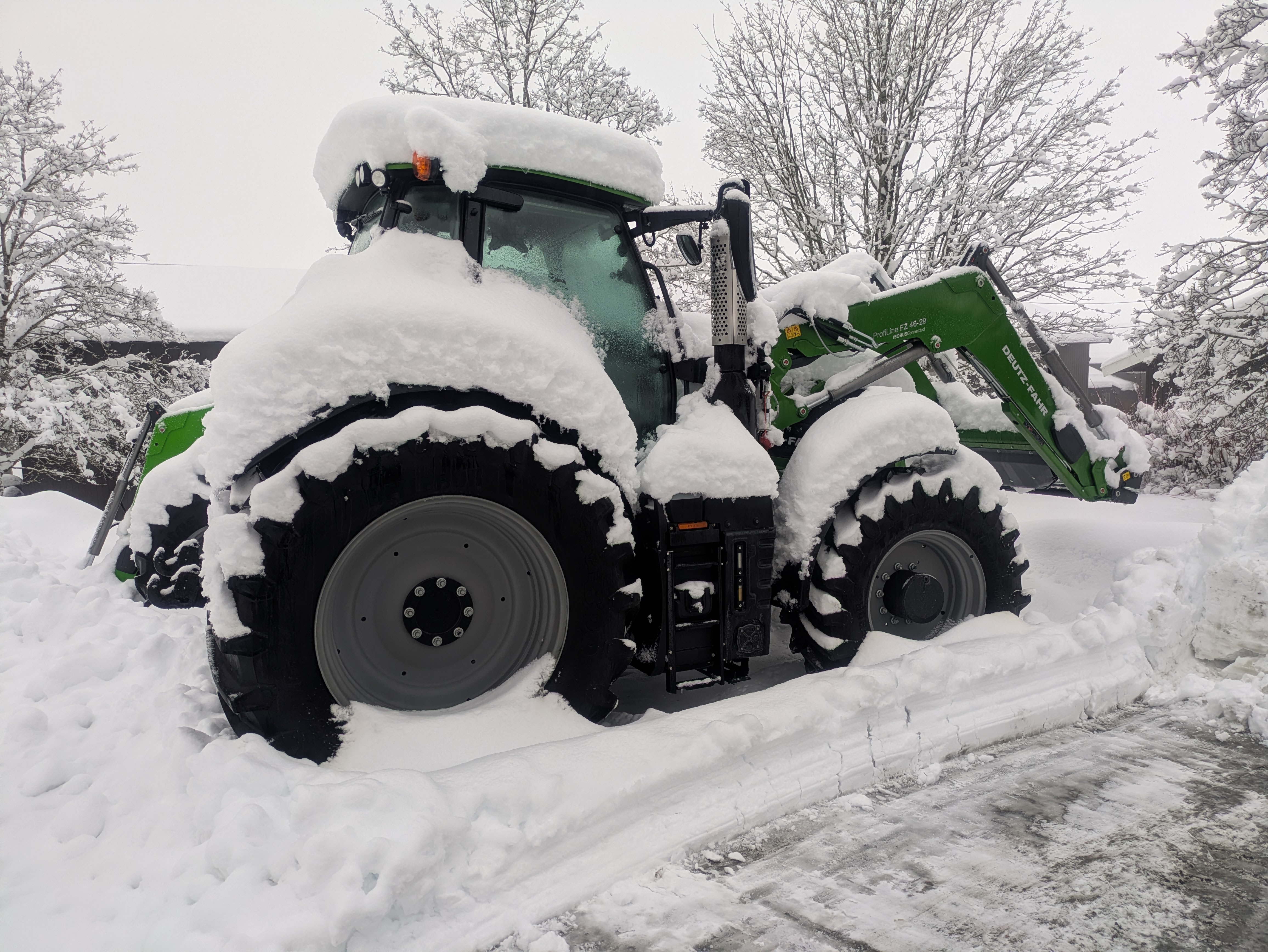 Tractor covered in snow during winter on the farm in Fetsund, Norway
